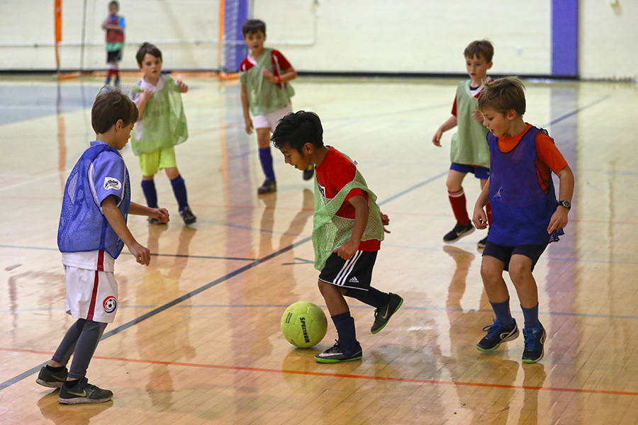 Children playing indoor soccer.